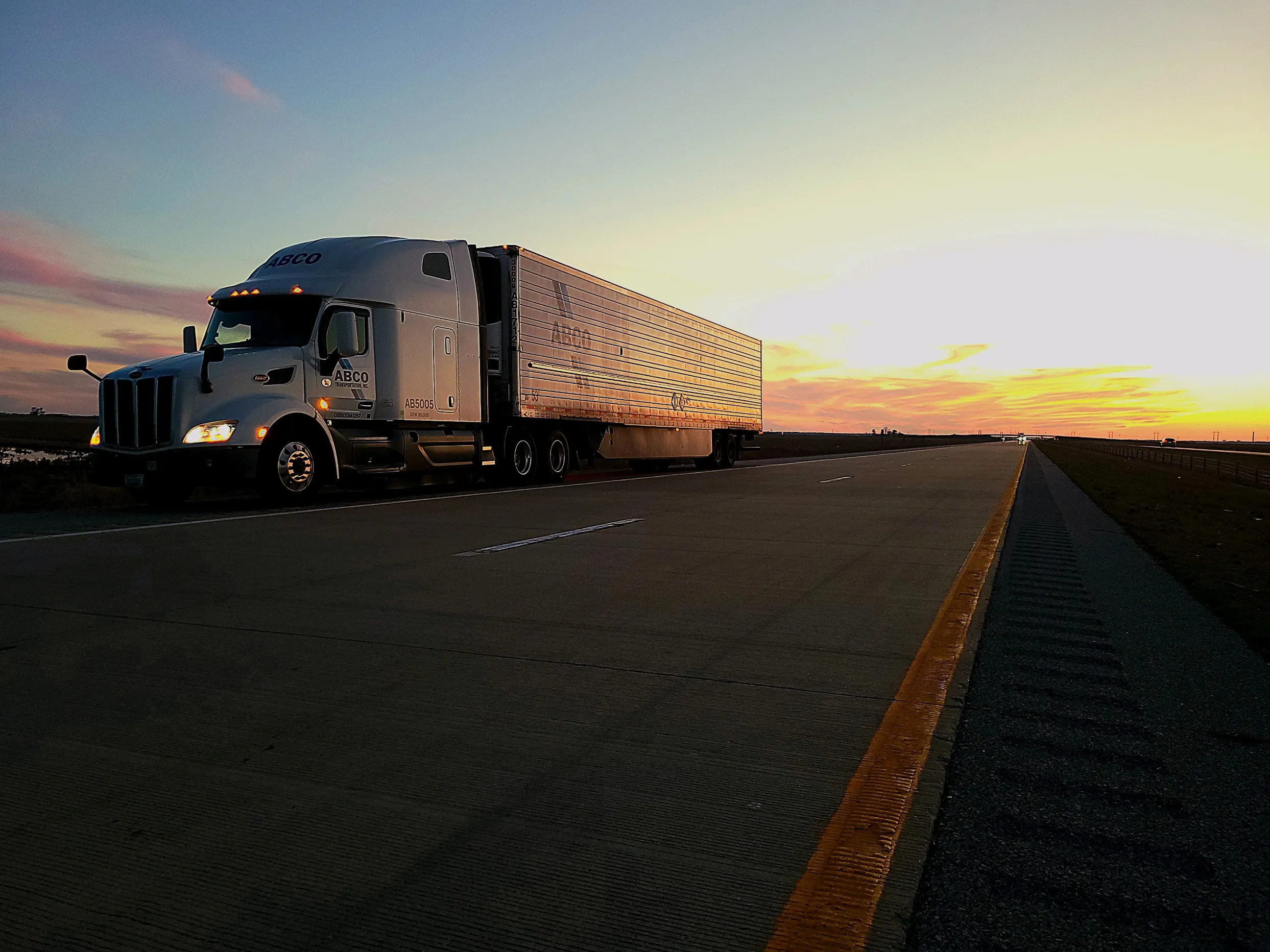 ABCO tractor-trailer on the highway at sunset